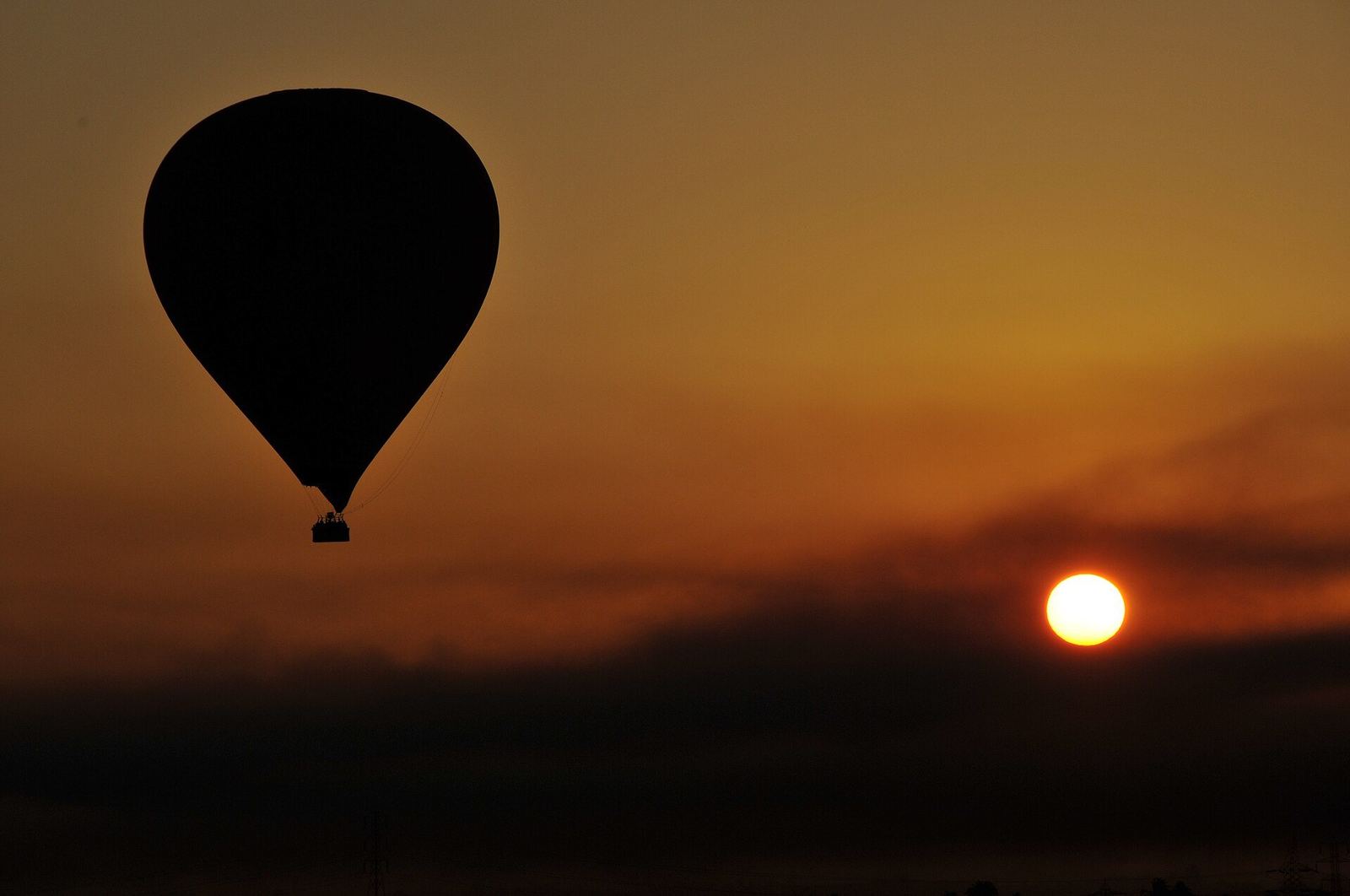 A hot air balloon over Luxor's West Bank at dawn