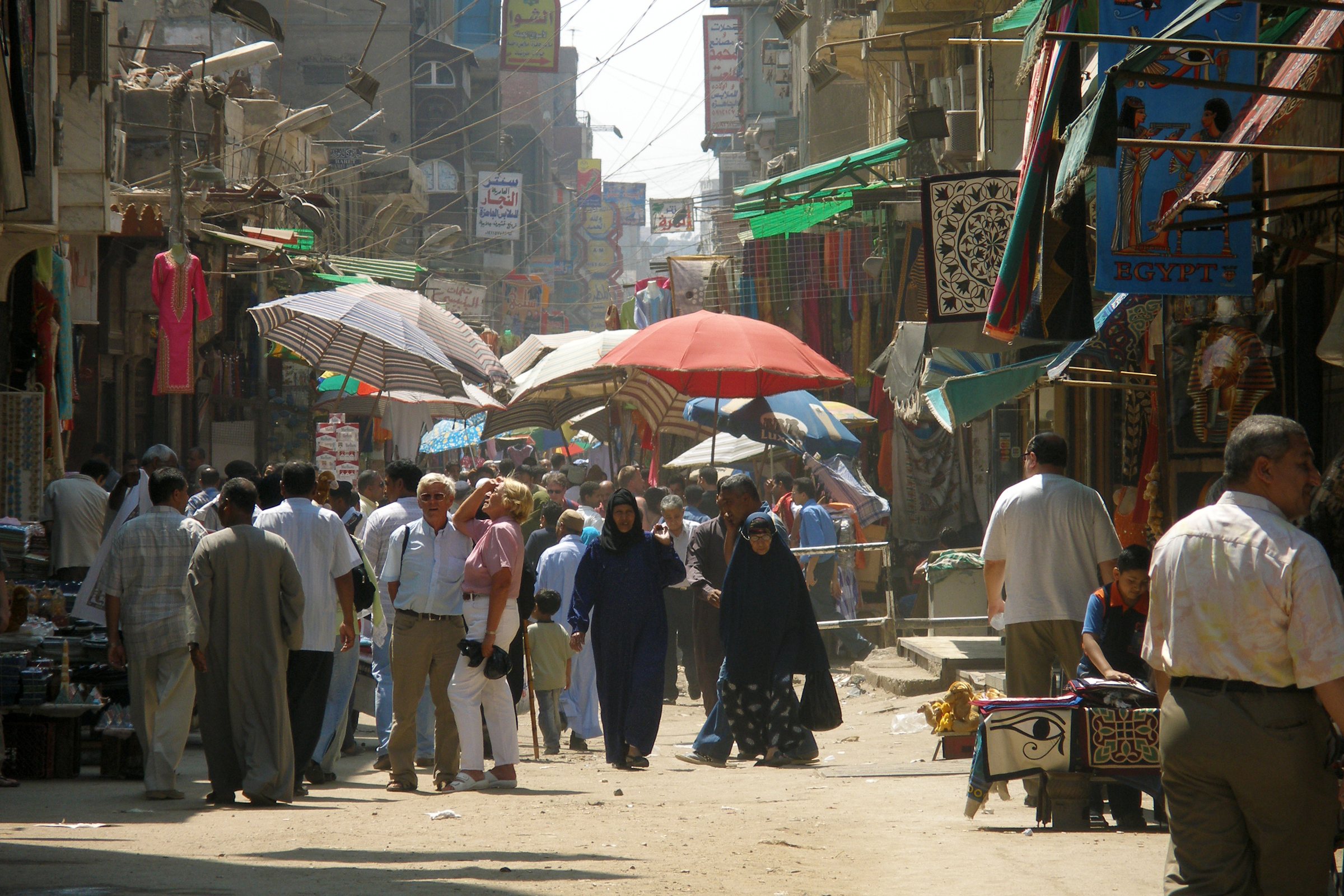 Shoppers and market stalls on a street of Islamic Cairo